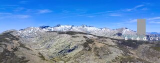 Una vista panorámica de un paisaje montañoso con picos rocosos y cielo azul en la Sierra de Gredos.